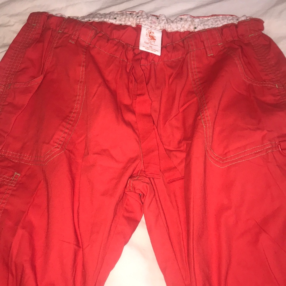 Kathy Peterson red scrub pants w/ green stitching